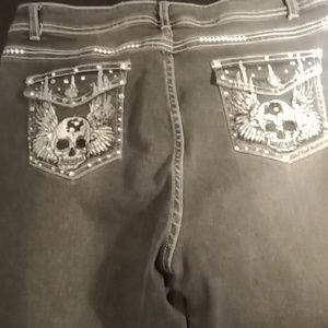 Grayish blackish jeans! They have skulls on them!
